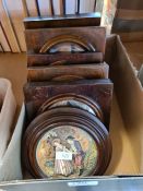 Six old pot lids in wooden frames