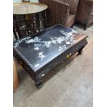 A Chinese lacquer oblong coffee table having inlaid decoration of flowers and birds, 81cm
