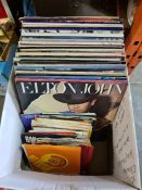 A quantity of vinyl LP records including Elton John Captain Fantastic, and 7" singles