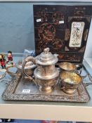 An Indian white metal four piece tea and coffee set, decorated with panels of animals and a similar