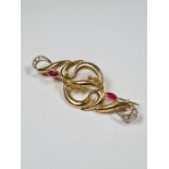 18ct yellow gold fancy brooch inset two marquise rubies and clear stones each end, marked 750, 5cm,