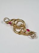 18ct yellow gold fancy brooch inset two marquise rubies and clear stones each end, marked 750, 5cm,
