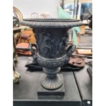 A pair of Classical style small bronze urns, the body decorated figures on square base, each 35cms h