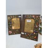 A pair of brass easel photoframes with enamelled floral decoration, 23cms high