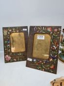 A pair of brass easel photoframes with enamelled floral decoration, 23cms high