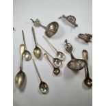 The silver decorative spoons, possibly continental having beaded details, pierced decoration and cri