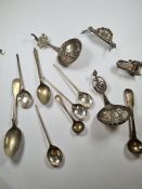 The silver decorative spoons, possibly continental having beaded details, pierced decoration and cri