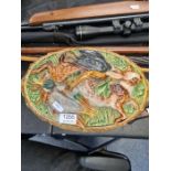 An old Majolica and Game pie dish with liner, the lid decorated birds and hare, 35cms