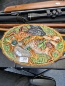 An old Majolica and Game pie dish with liner, the lid decorated birds and hare, 35cms