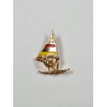 18ct yellow gold pendant in the form of a windsurfer with enamelled flat, marked 750, approx 1.93g