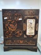 A Chinese black lacquer miniature chest with six drawers and three internal drawers, the door having
