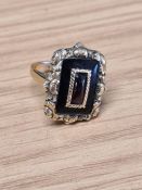 Antique yellow gold mourning ring with central cabochon rectangular garnet surrounded black enamel p