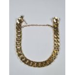 Heavy 18ct gold flat curb link bracelet of chunky fashion, marked 750, and safety chain, approx 67.4