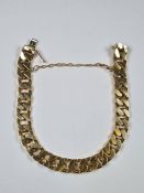 Heavy 18ct gold flat curb link bracelet of chunky fashion, marked 750, and safety chain, approx 67.4