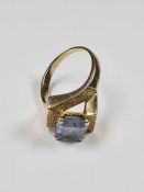 9ct yellow gold dress ring with crossover square textured mount and central blue paste step cut ston