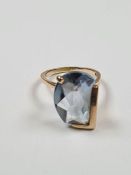 9ct yellow gold dress ring with fancy asymetric pale blue gemstone, in asymetric setting, marked 9ct