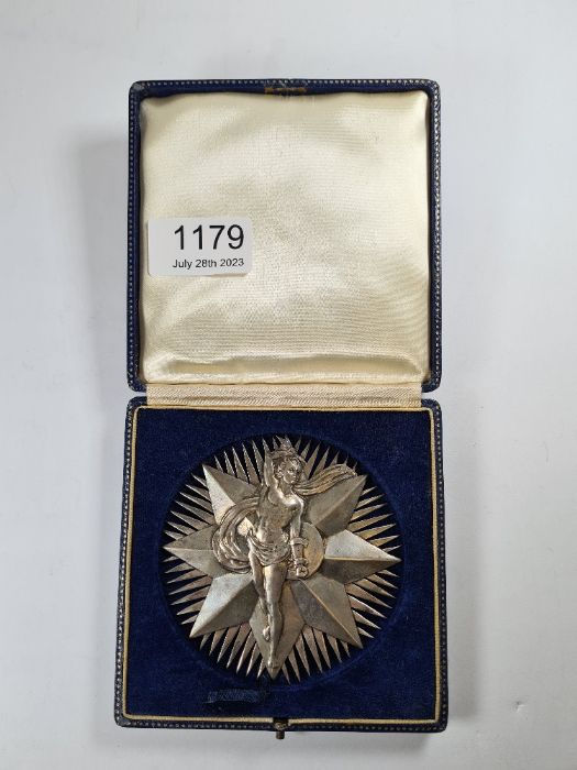 A silver medal by Bravingtons Ltd, Birmingham 1966, of star motif form, having a male figure in reli