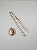 9ct yellow gold belcher chain marked 9ct , hung with a large oval 9ct gold locket with engraved flor