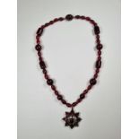 Victorian Bohemian garnet and cherry amber bead necklace hung with a pendant comprising mixed cut ga