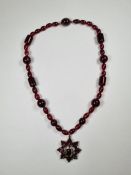 Victorian Bohemian garnet and cherry amber bead necklace hung with a pendant comprising mixed cut ga