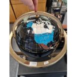 A modern table top globe having inlaid mineral countries