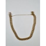 18ct yellow gold curb link bracelet of hollow designed links, marked 750, with safety chain, approx