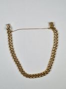 18ct yellow gold curb link bracelet of hollow designed links, marked 750, with safety chain, approx