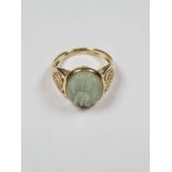 14K yellow gold oriental design ring with character marks to shoulders and carved oval nephrite pane