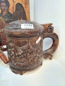 A late 19th Century carved lidded tankard decorated Huntsman in mountainous landscape, and a box of