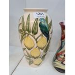 A modern Moorcroft vase decorated birds and lemons, in a cream field, 26cm approx