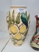 A modern Moorcroft vase decorated birds and lemons, in a cream field, 26cm approx