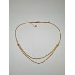 18ct yellow gold Omega in necklace with double row suspended leaf decorated panel with brush finishe