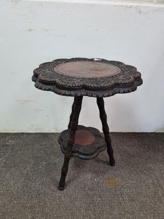 Burmese carved two tier occasional table having shaped top
