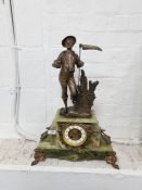 A late 19th/early 20th century onyx mantel clock having gilt metal mounts with Spelter figure of far