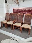 A set of eight modern dining room chairs with cane backs
