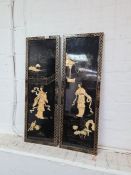 A pair of Chinese style oblong lacquer plaques decorated figures