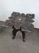 A carved hardwood Anglo-Indian occasional table having folding base with square top