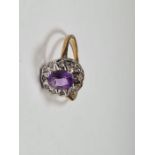 Modern 9ct yellow gold cluster ring with central oval faceted amethyst surrounded diamond chips, siz