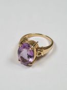 9ct yellow gold dress ring set with large oval mixed cut amethyst in 4 claw mount decorative heart s