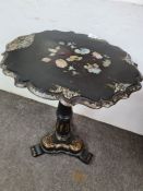 A Victorian papier-mâché occasional table having gilt and floral decoration on tri-form base
