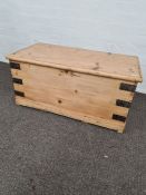A smaller stripped pine blanket box