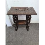 A Burmese carved two tier occasional table with lion carving