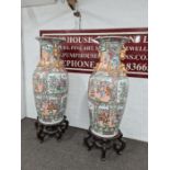 A pair of very large Chinese vases on carved wooden stands - one badly damaged (105cm height x 58cm