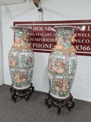 A pair of very large Chinese vases on carved wooden stands - one badly damaged (105cm height x 58cm