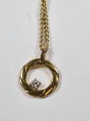 9ct yellow gold neckchain with magnetic clasp, hung with a 9ct gold circular pendant set with a bril