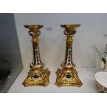 A pair of Royal Crown Derby Old Imari pattern, candlesticks on square shaped base (one damaged)