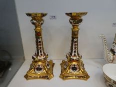 A pair of Royal Crown Derby Old Imari pattern, candlesticks on square shaped base (one damaged)