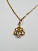 8ct yellow gold fine neckchain, marked 333, hung with an unmarked yellow metal pendant inset with a