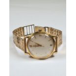 Omega; an 18ct gold cased Omega watch with champagne dial, baton markers on gold plated strap, in or