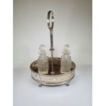 A Georgian silver cruet stand having a decorative engraved body, pierced details and beaded rim on f